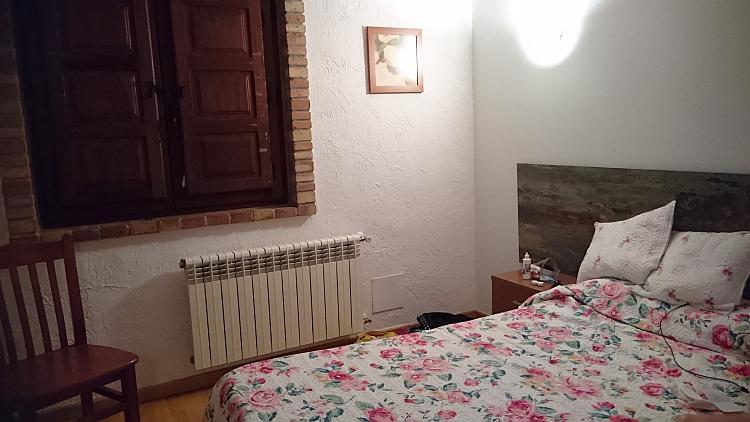 There's shutters on the window, a double bed and pleasant surroundings in the room