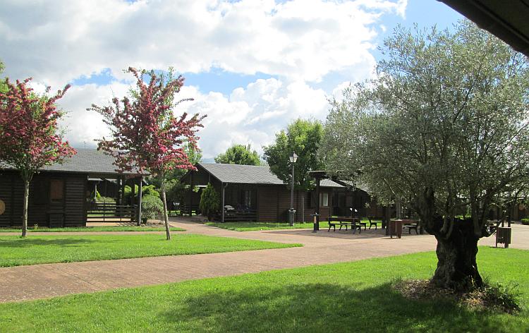 Trees and grass abound around the bungalows hiding very well the town beyond