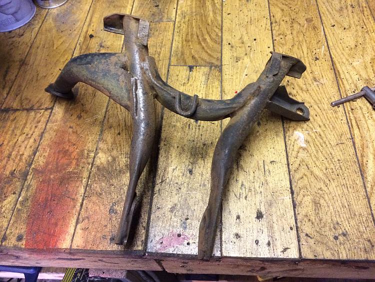 The rusty centre stand has had the loose mud, dirt and rust removed so far