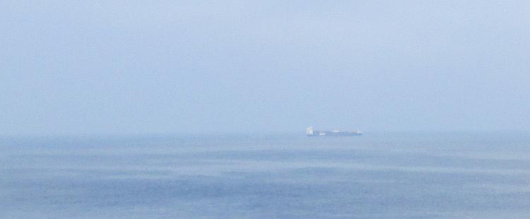 A distant ship way across on the horizon can just be made out