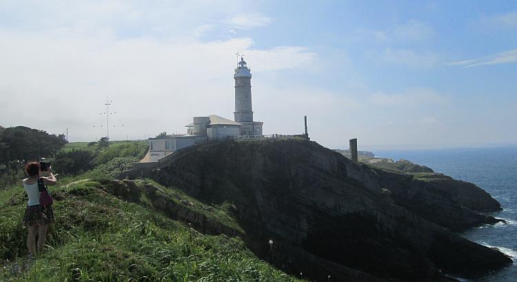 Looking back from the promontory we see the lighthouse and the sea cliffs