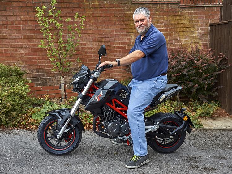 Mr Shuttleworth sits upon his TnT125 with a wry smile