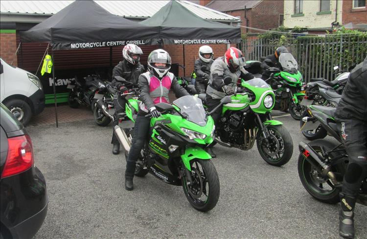 Sharon sat on the Ninja 400 ready to ride and smiling within her helmet