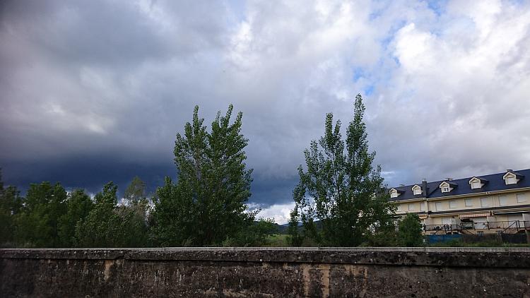 Thick heavy clouds darken the skies over the town