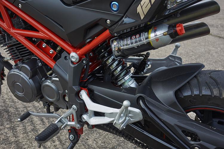 Under the rear seat unit above the rear wheel is mounted a can of tyreweld