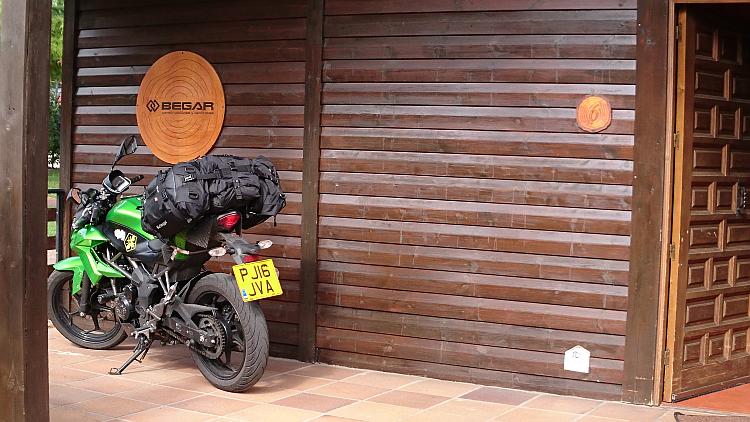 Sharon's Kawasaki Z250SL on the veranda of the wooden lodge