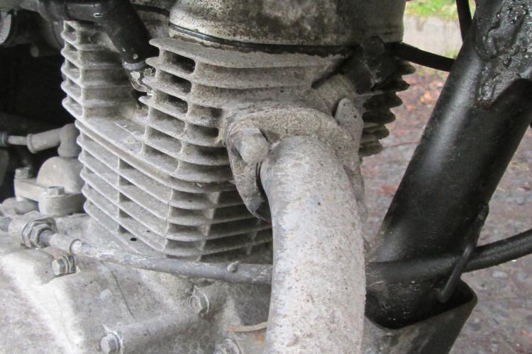 The engine on the 125 is caked in salt and dirt from a winter's ride