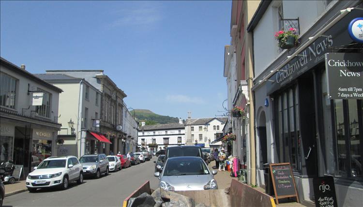 The main street has shops and shoppers and a mish-mash of building