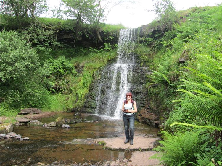 In the small ravine made by the small waterfall all is green and lush