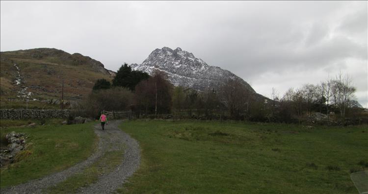 Behind the hilly rough hillsides of the campsite a towering rocky mountain rises