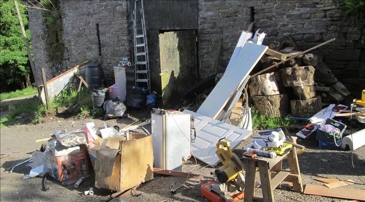Tools, building material and general items strewn across the driveway at the site