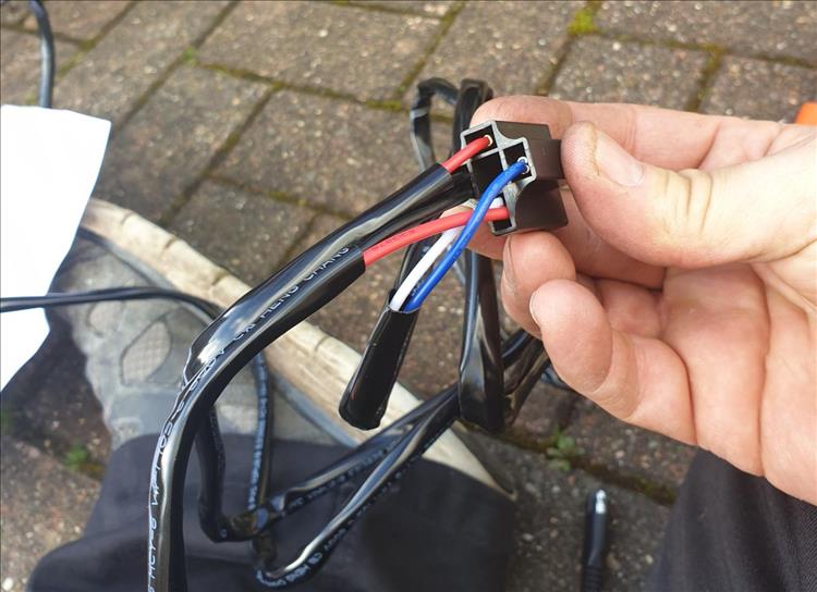 Pete is holding a wiring block, there's wires all over the place
