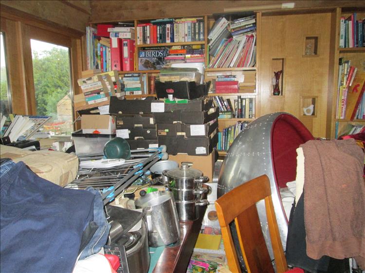 Piles of all kinds, boxes, pans, books, clothing, parcels, chair and lord only knows what else