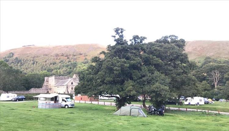 Abbey Farm Campsite with the abbey ruins in the background