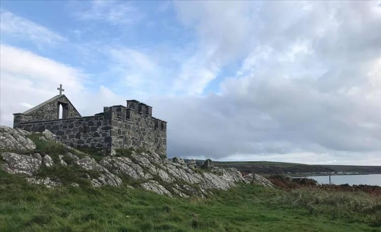 Stone built walls and a cross of the tomb near the campsite