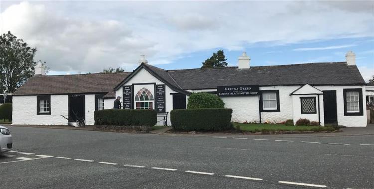 A long single story white building at Gretna, the famous Blacksmith's shop