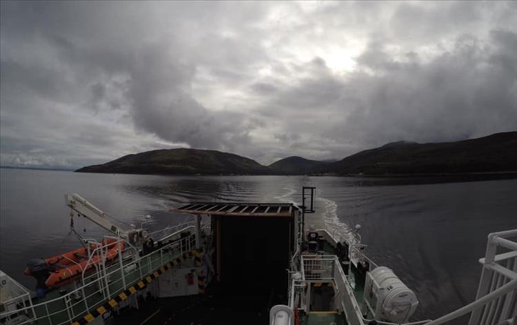 Looking out from the ferry the waters are dead calm but the skies are leaden grey.