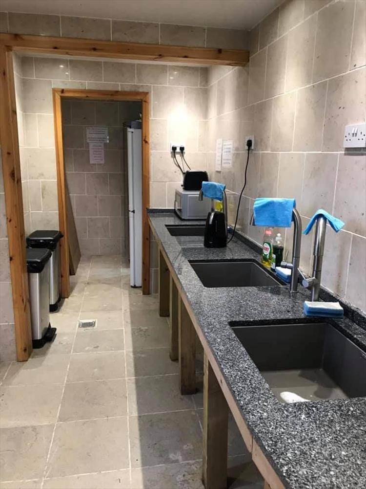 Smart clean tiles, wood trim, large sinks and a modern feel to the washing up area