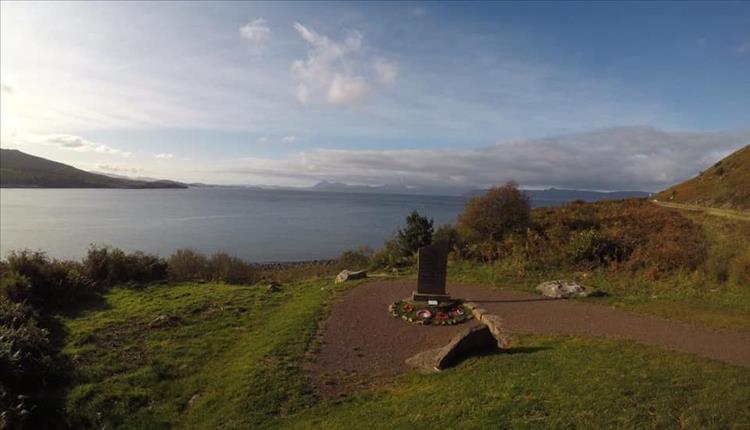 A small stone table with a few names and poppy wreaths to remember those who dies in the wars
