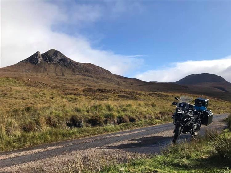 Andy's big BMW at the end of the narrow track along the shore, with a steep hill behind