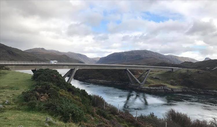 The sleek modern Kylesku bridge against the ancient and wild highland scenery