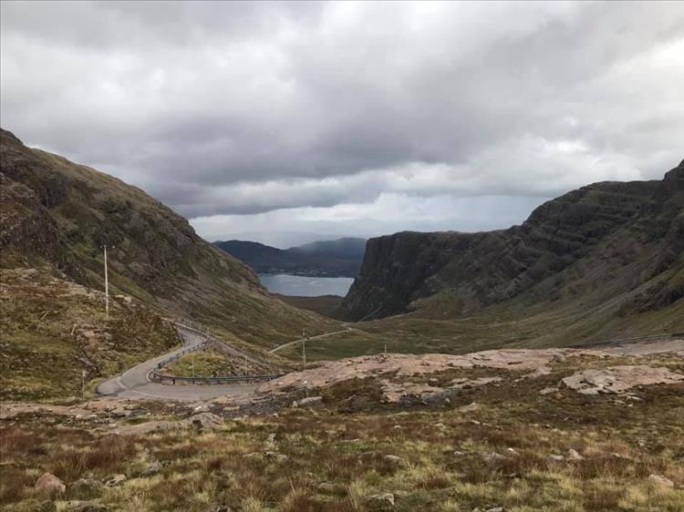 Looking back down the valley we see the twisting road of the pass of the cattle