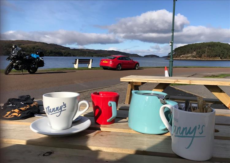 tea pot, cup, bench, andy's gs1200, the loch and the hills at the cafe