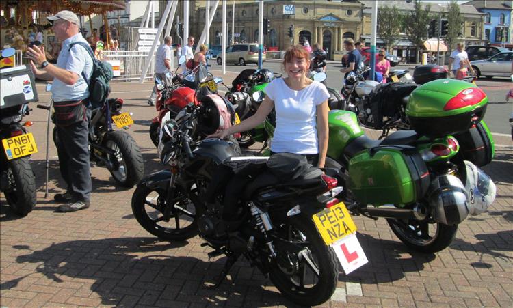 Sharon when she was a learner on her 125 smiling in the sun at Southport