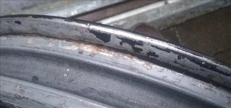 Close up of the rim showing poor paint and some corrosion