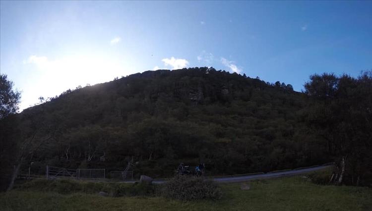 A large round hill above which we can just make out a large bird