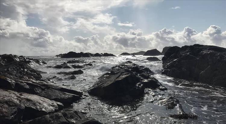 Sharp rocks breaking the waves coming into the shore at Iona