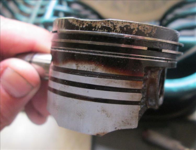 The piston has some carbon on it and the oil control rings are gummed