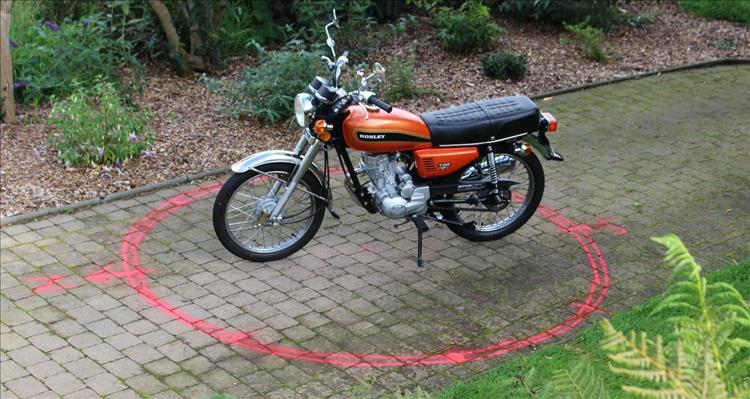 The Honley motorcycle in a chalk circle with various compass points drawn on the circle