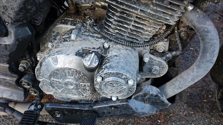 Sharon's usually very clean motorcycle is covered in dirt
