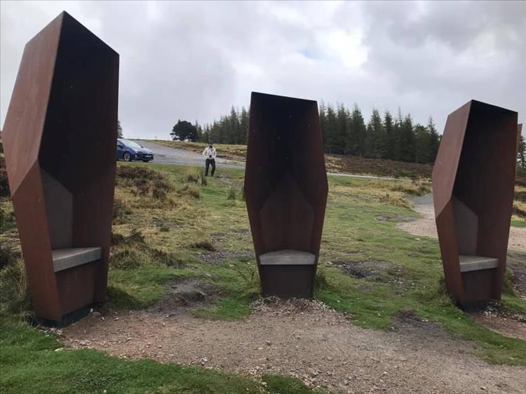 steel shelters look oddly coffin shaped in rusty steel on the route out of Lecht
