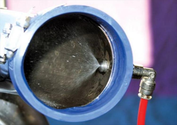 Water being injected as a mist into the throttle body