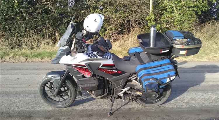 Ren's Honda is lightly loaded parked by trees on a country lane in rare winter sunshine