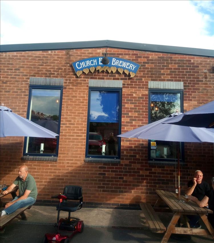 The brick outside of a pub and a sign stating Church End Brewery