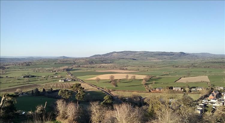 From the high castle we look over arable farmland and the town, more hills in the distance
