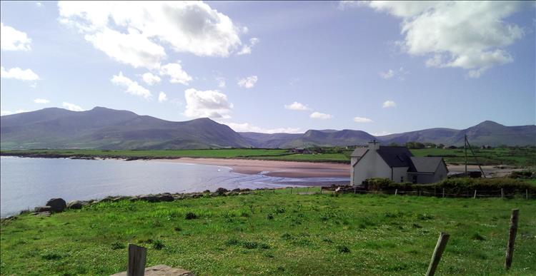 A humble house on the shores of a beautiful mountain backdrop in Kerry