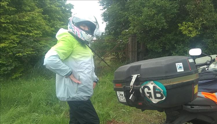 Sharon posing in her helmet and waterproof riding gear