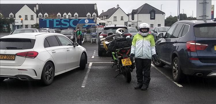 Sharon in waterproofs looking soggy in a Tesco car park