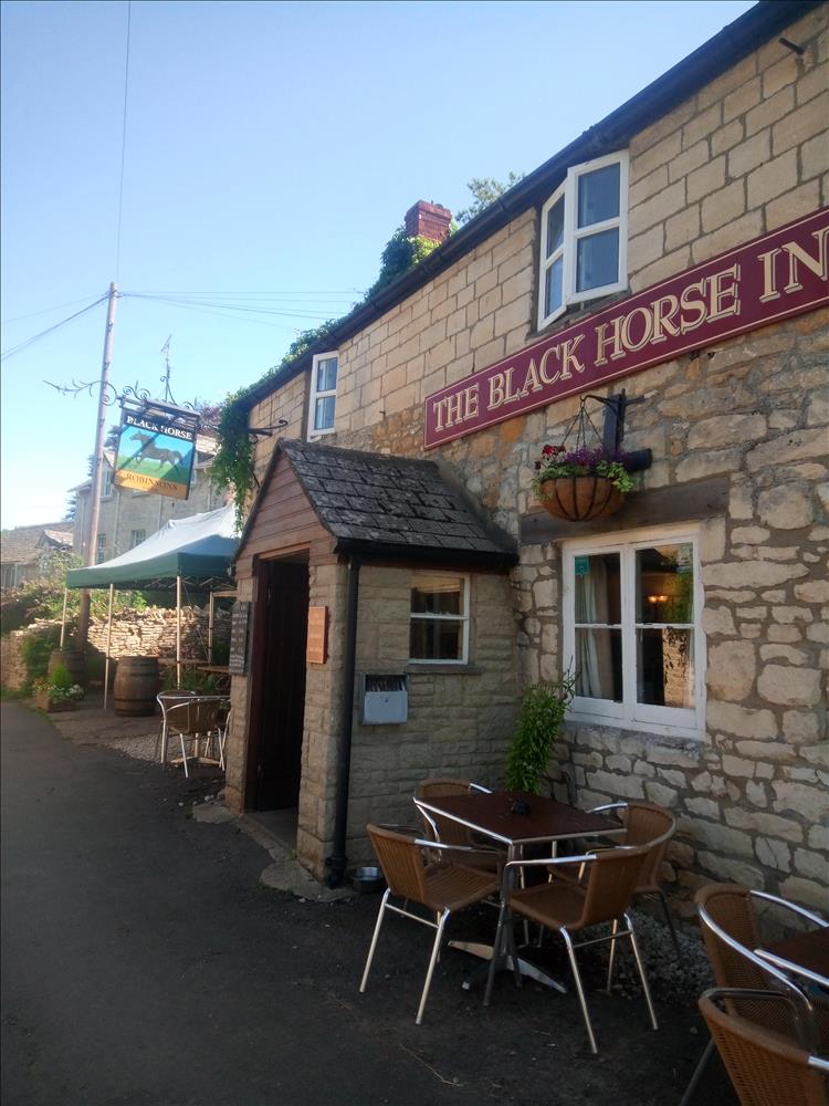 The pub in Cranham, a pretty stone built building in the sunshine