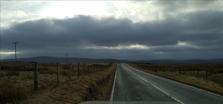 Sunshine and heavy skies over vast Welsh moorland and mountains