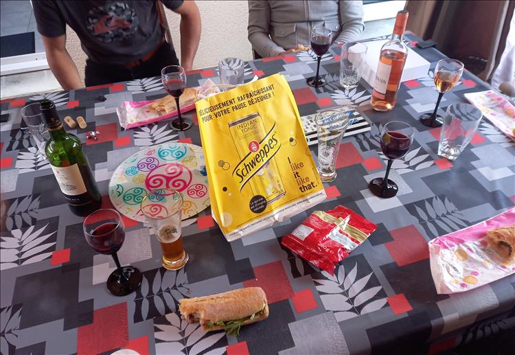 The table is filled with plates and food and drinks again