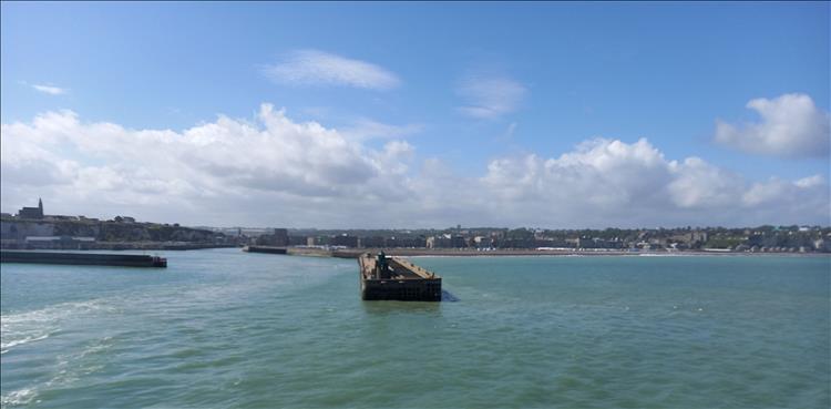 Looking inland from the sea there's the harbour wall and the town of Dieppe