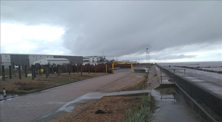 Large commercial buildings, rough and ready car parks, concrete sea defences and heavy skies
