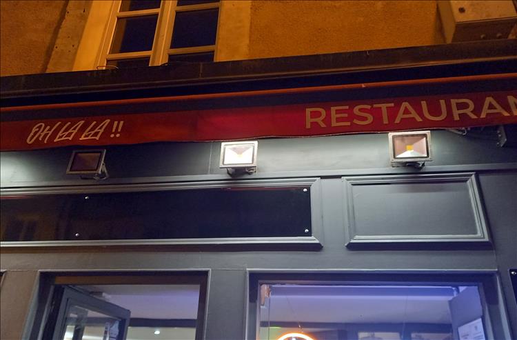 The sign above the shop front reads Oh La La Restaurant.