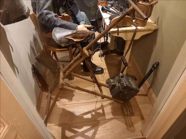 What appears to be a very old exercise bicycle with a box around the pedals