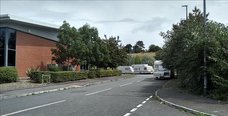 Rough, ramshackle caravans around an industrial area in Glastonbury